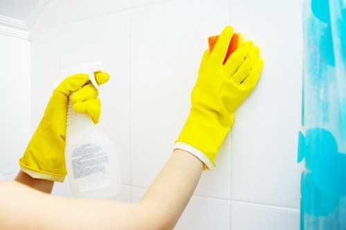 Technician performing oven cleaning in a Merton property