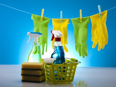 Oven cleaner using protective gloves during service